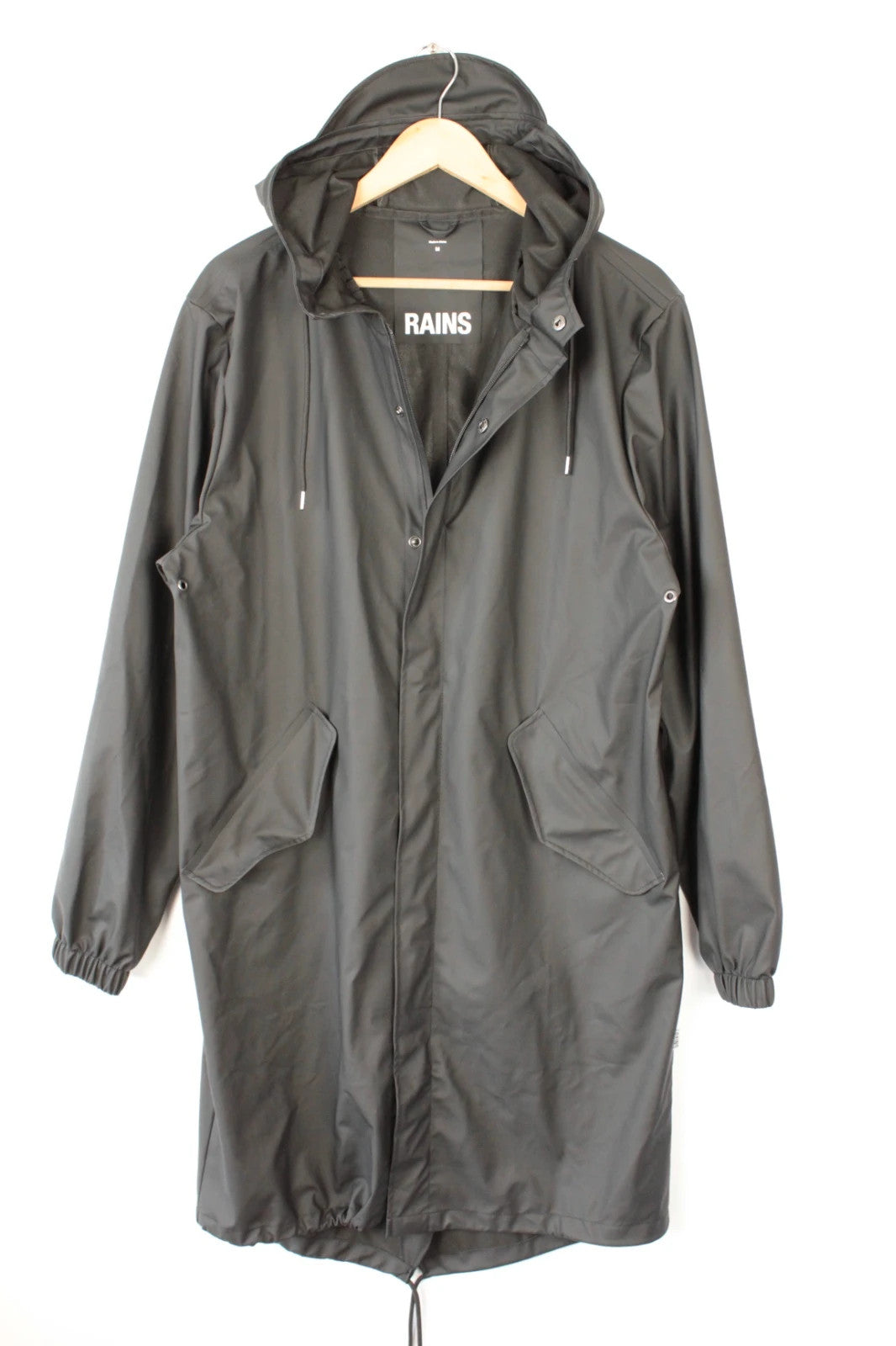 Rains black fishtail parka jacket with adjustable hood and matte finish.