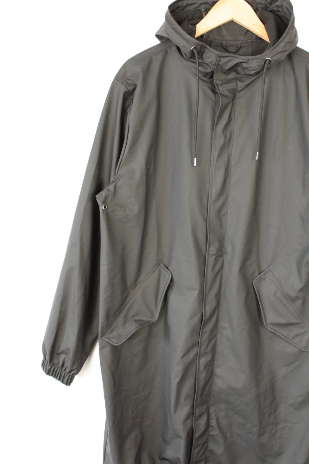Rains black fishtail parka jacket with adjustable hood and matte finish.
