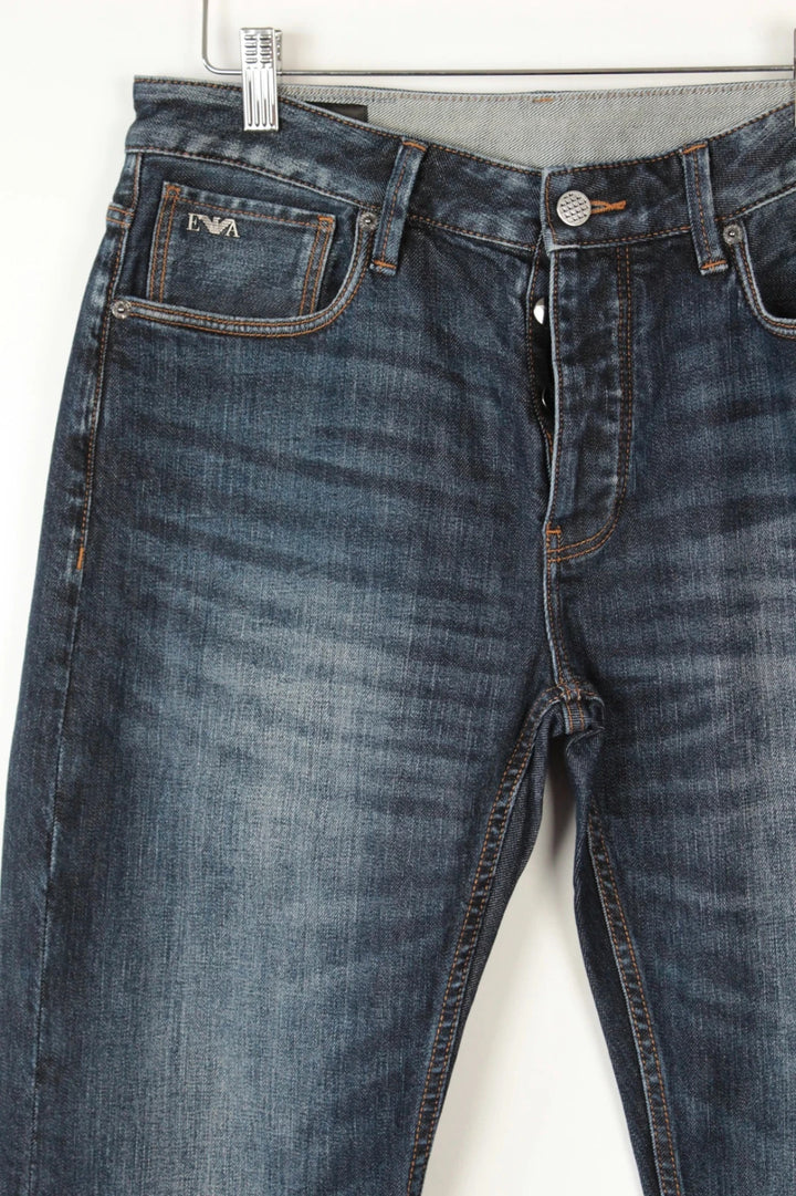 Emporio Armani navy slim jeans with metal eagle logo and leather waist patch.