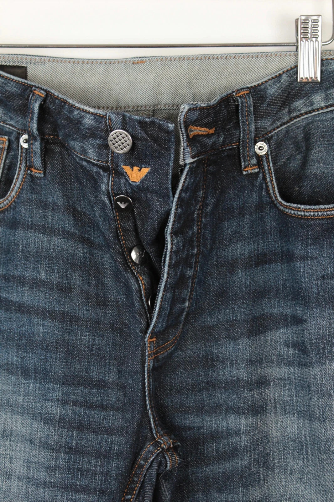 Emporio Armani navy slim jeans with metal eagle logo and leather waist patch.