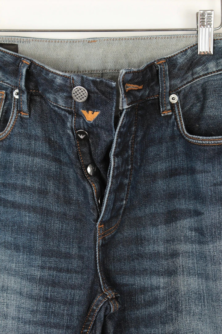 Emporio Armani navy slim jeans with metal eagle logo and leather waist patch.