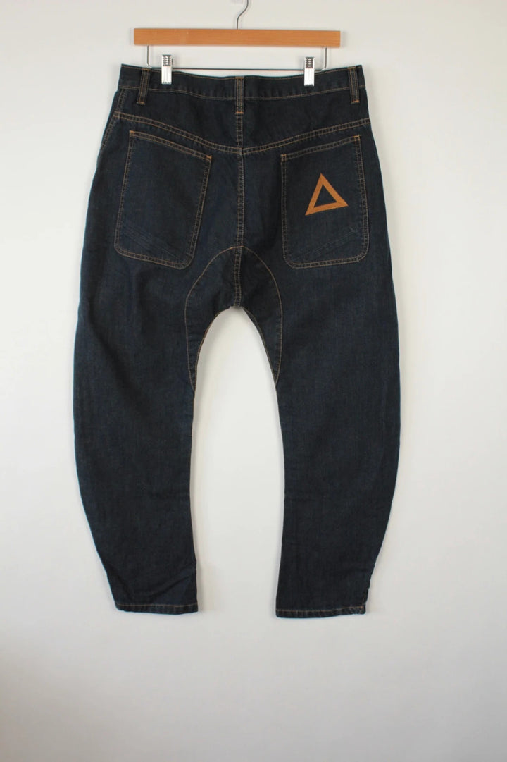 Aqua black and navy wide-leg trousers with tan triangle patch and contrast stitching.