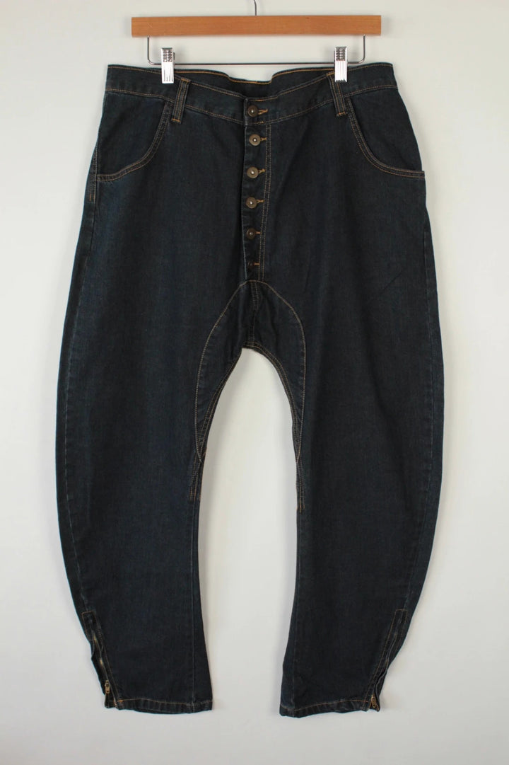 Aqua black and navy wide-leg trousers with tan triangle patch and contrast stitching.