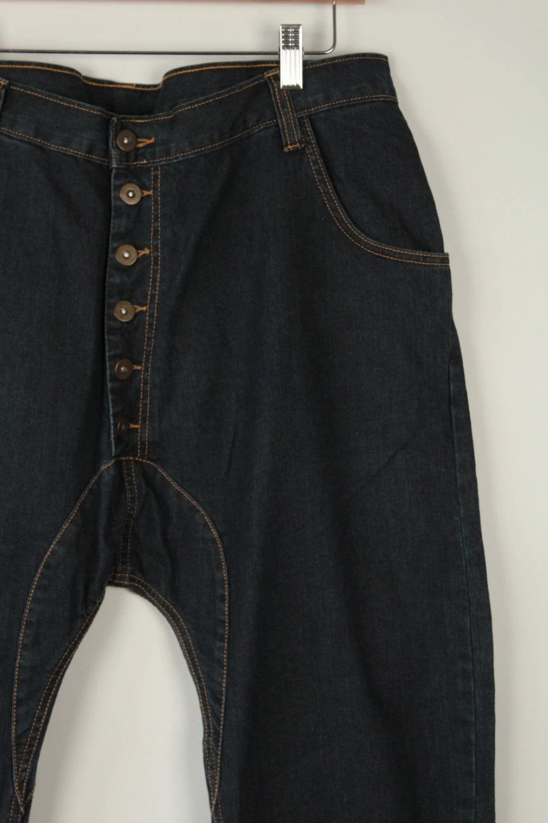 Aqua black and navy wide-leg trousers with tan triangle patch and contrast stitching.