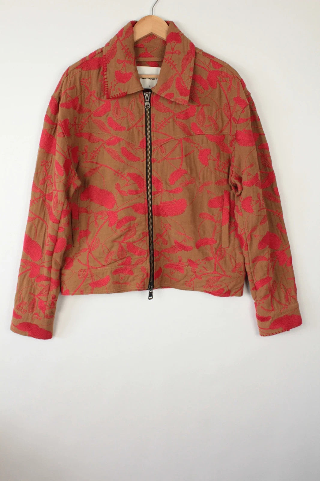 Andersson Bell brown zip-up jacket with vibrant red floral embroidery and logo rivets.