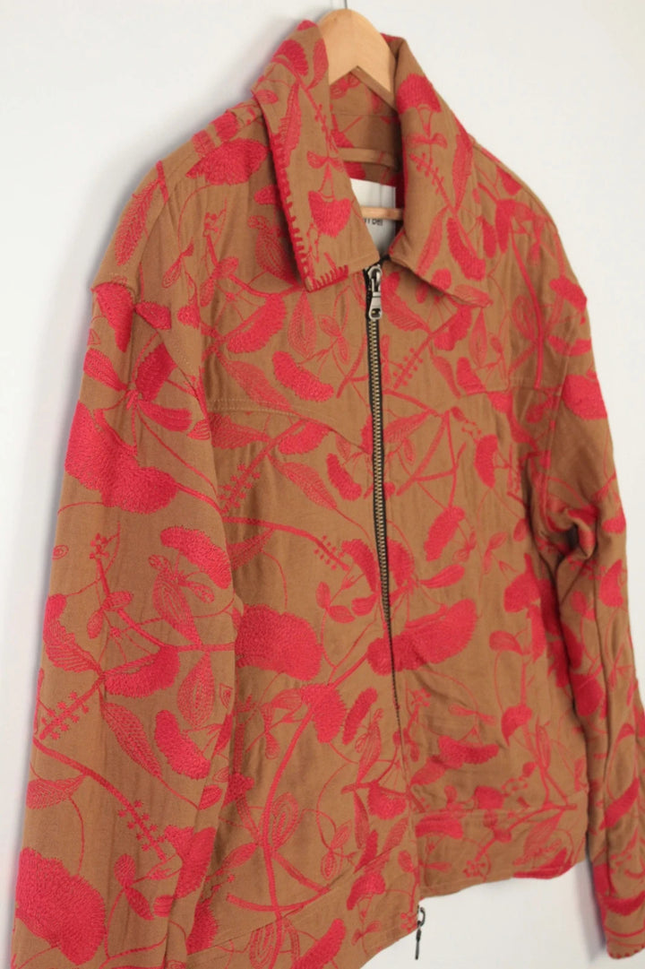 Andersson Bell brown zip-up jacket with vibrant red floral embroidery and logo rivets.