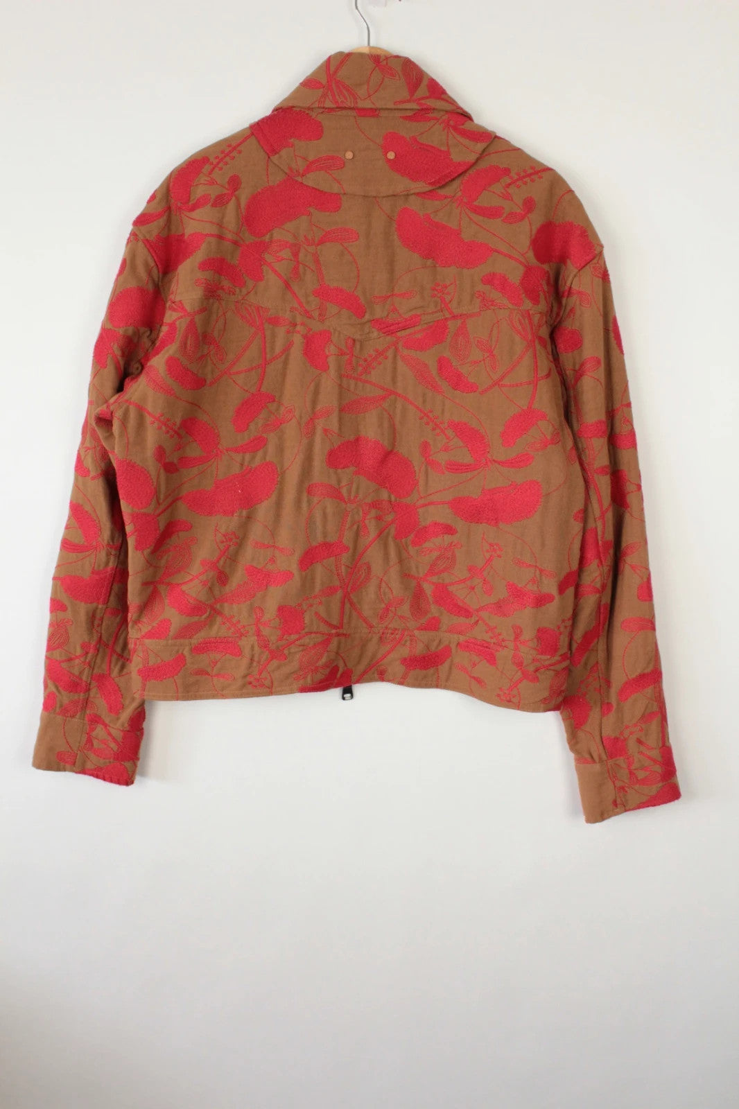 Andersson Bell brown zip-up jacket with vibrant red floral embroidery and logo rivets.