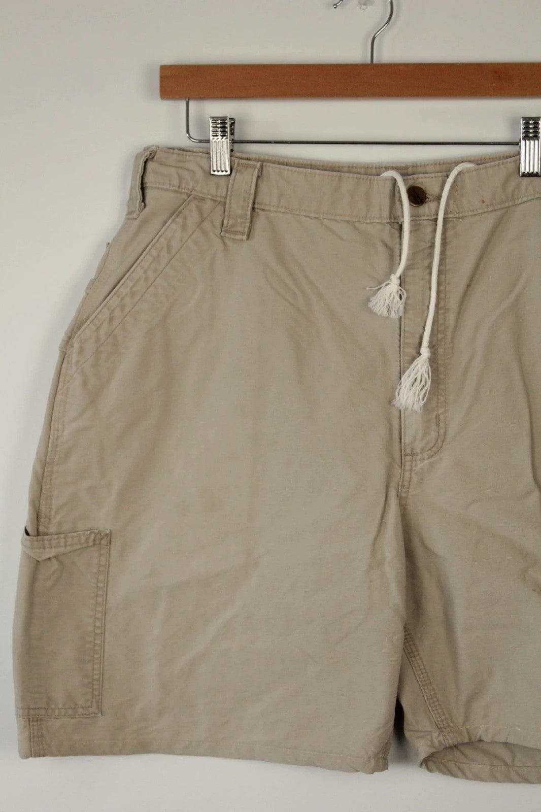 Carhartt beige canvas shorts with drawstring waist and leatherette logo patch.