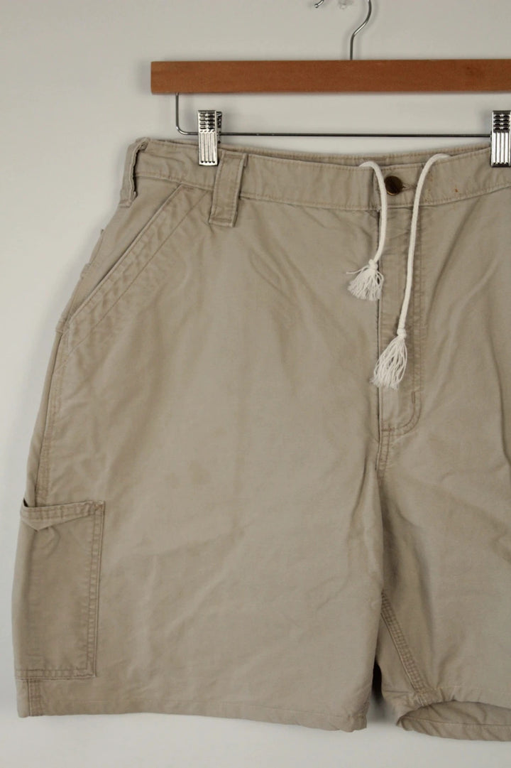 Carhartt beige canvas shorts with drawstring waist and leatherette logo patch.