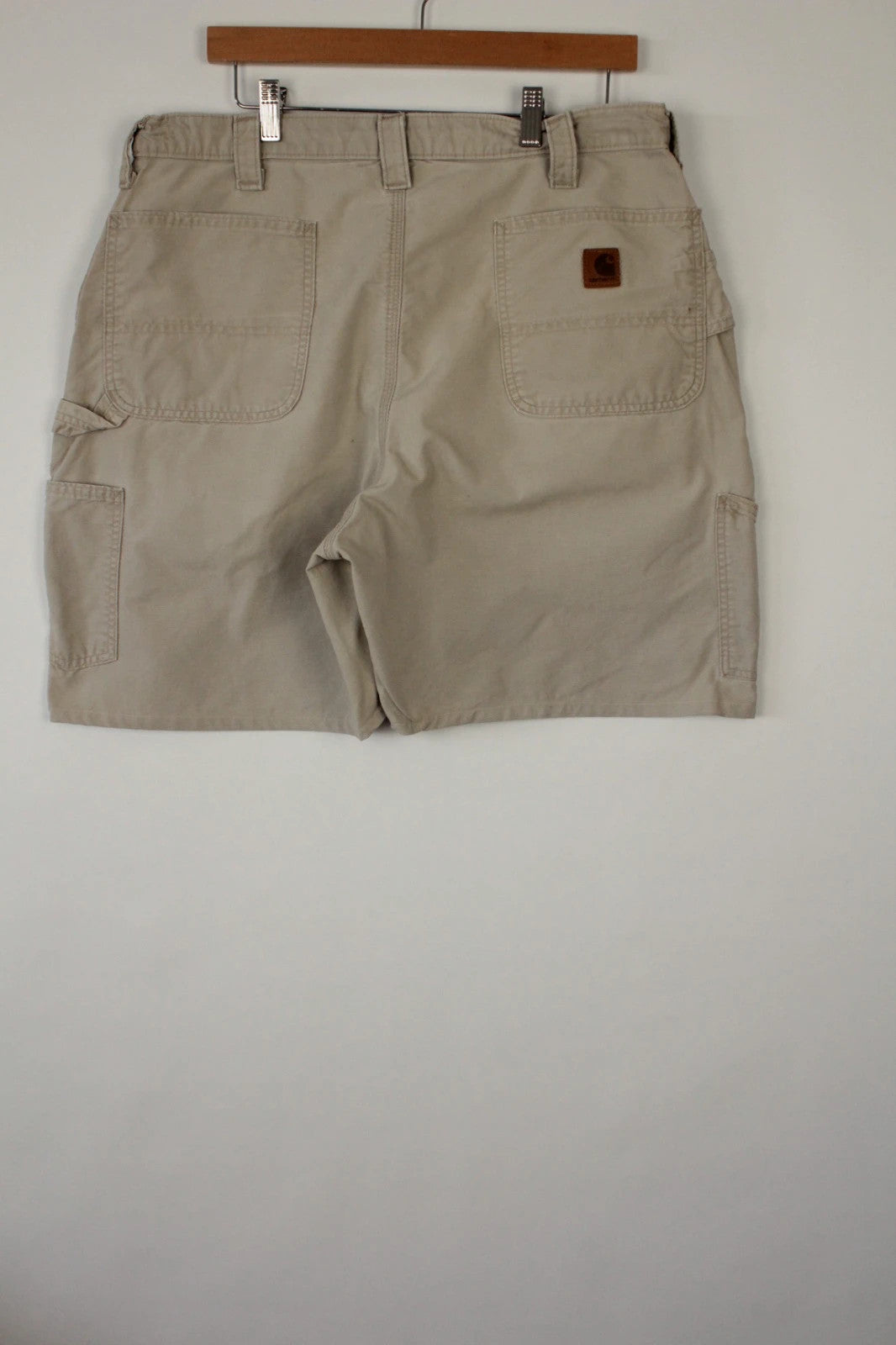 Carhartt beige canvas shorts with drawstring waist and leatherette logo patch.