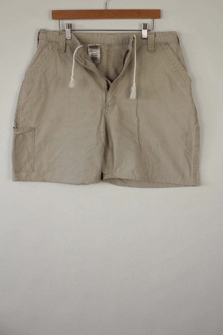 Carhartt beige canvas shorts with drawstring waist and leatherette logo patch.
