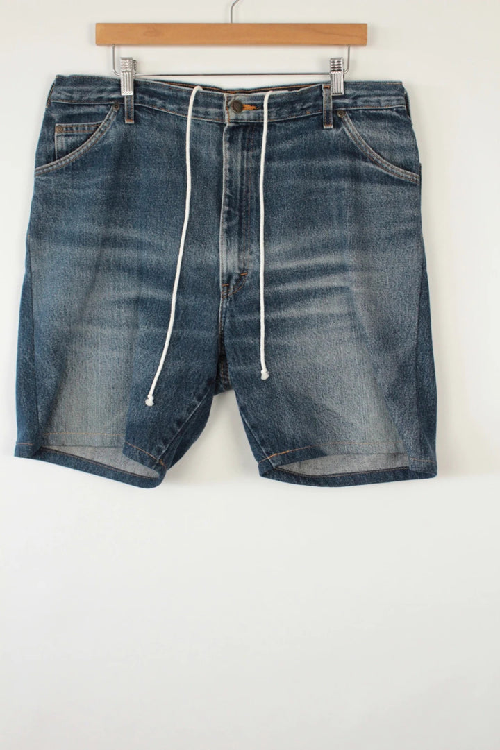 Dickies blue denim shorts with elastic drawstring waist and woven horseshoe logo patch.