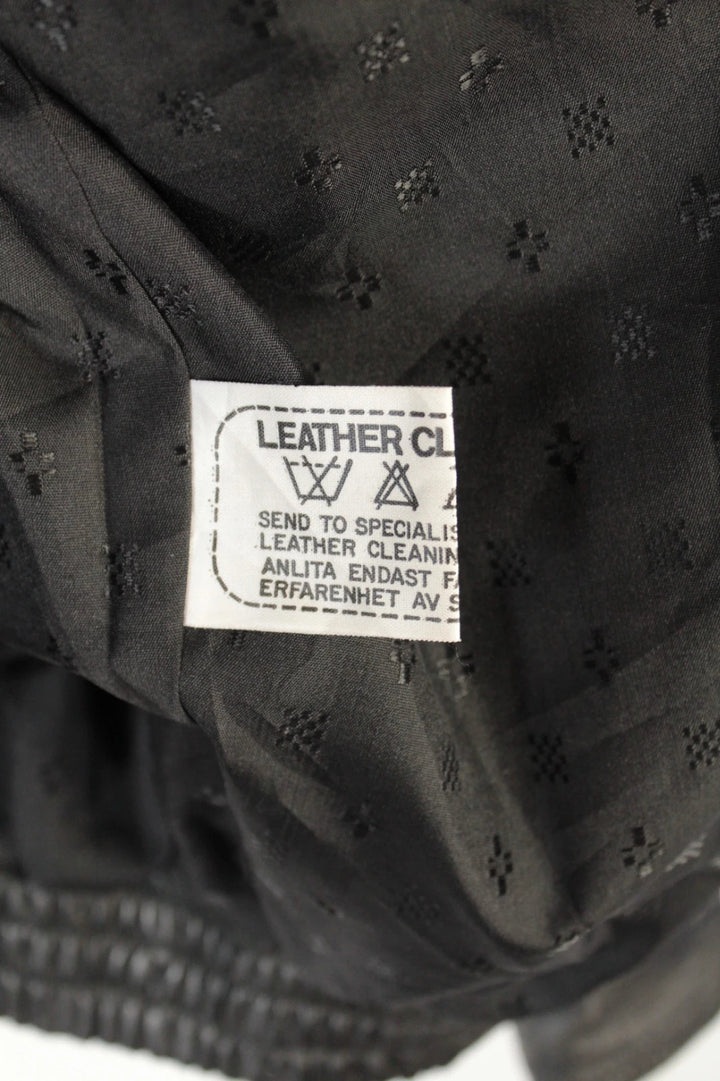 Vintage Dressing black bomber jacket, genuine leather, heavyweight, with utility arm pocket and satin lining.