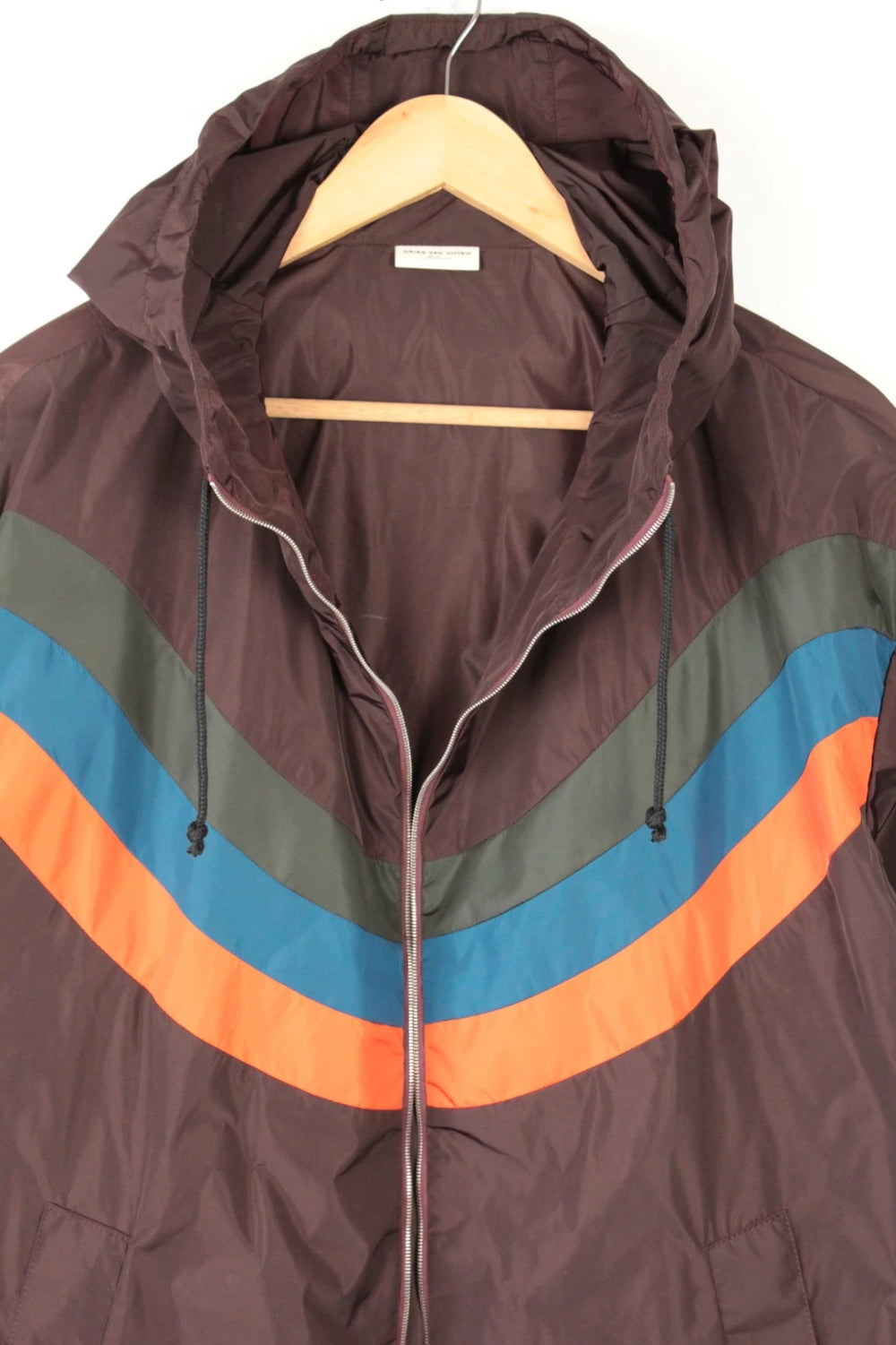Dries Van Noten brown windbreaker jacket with multi-coloured chevron stripes and silver zipper.