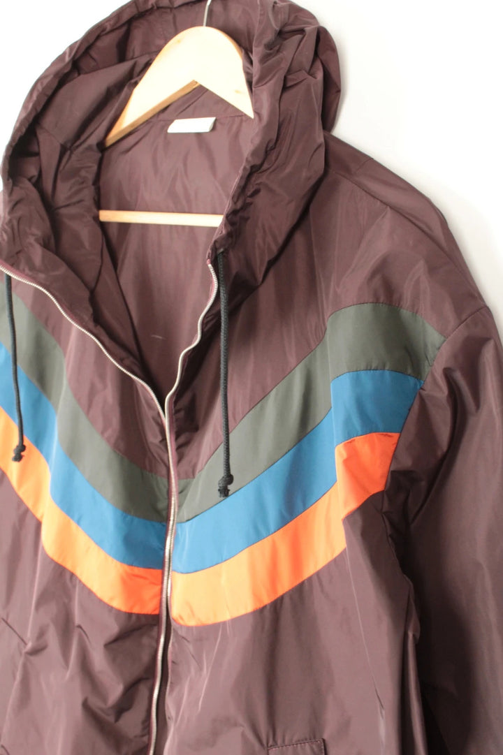 Dries Van Noten brown windbreaker jacket with multi-coloured chevron stripes and silver zipper.