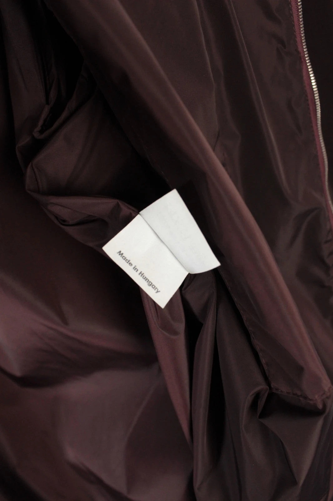 Dries Van Noten brown windbreaker jacket with multi-coloured chevron stripes and silver zipper.