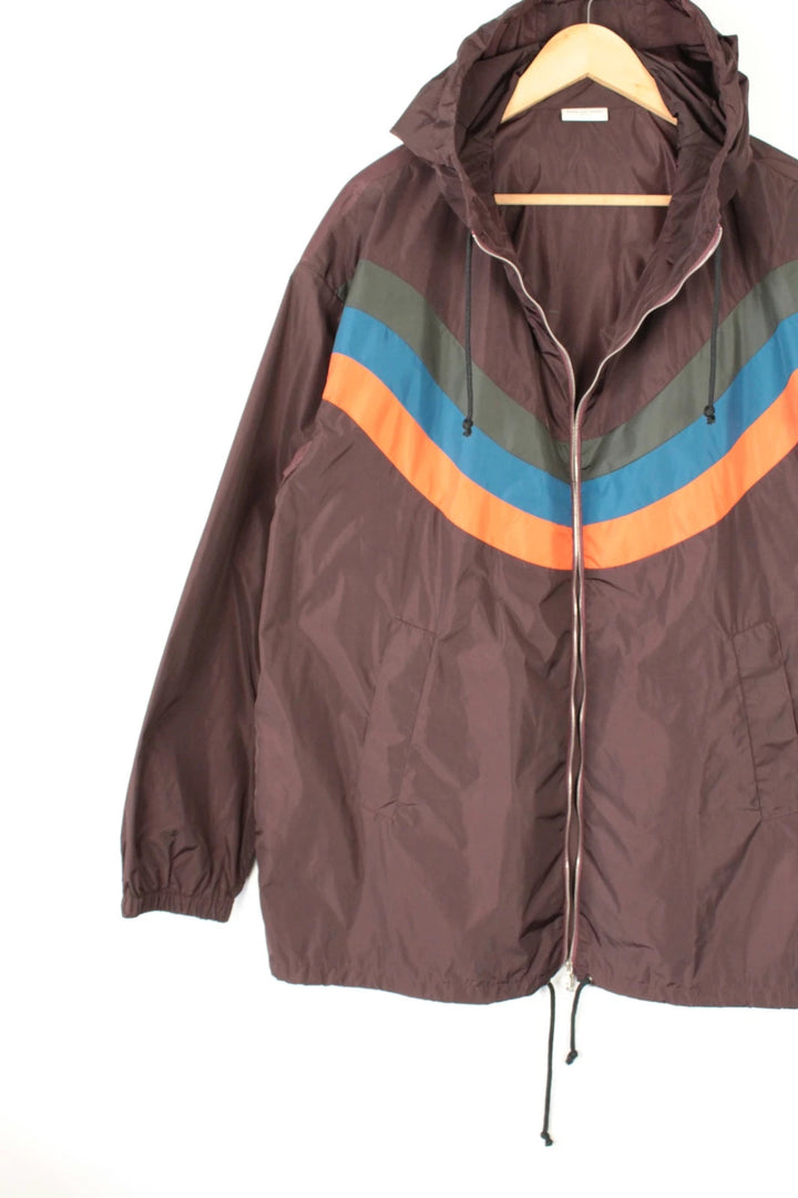 Dries Van Noten brown windbreaker jacket with multi-coloured chevron stripes and silver zipper.