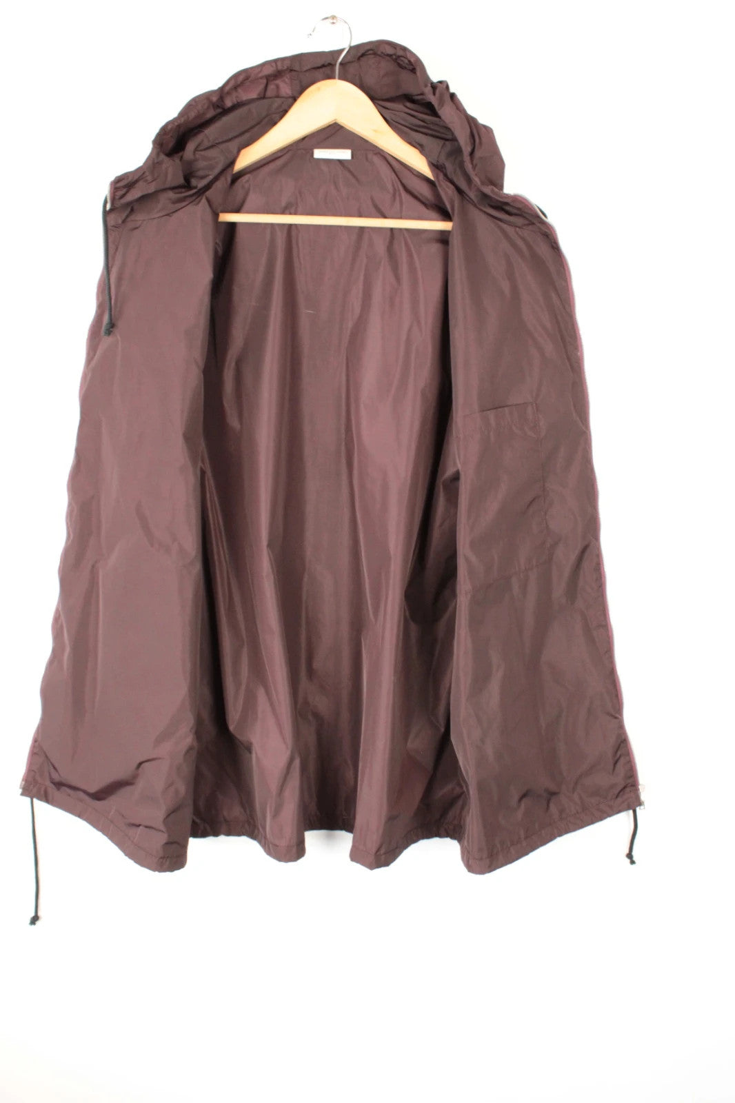Dries Van Noten brown windbreaker jacket with multi-coloured chevron stripes and silver zipper.