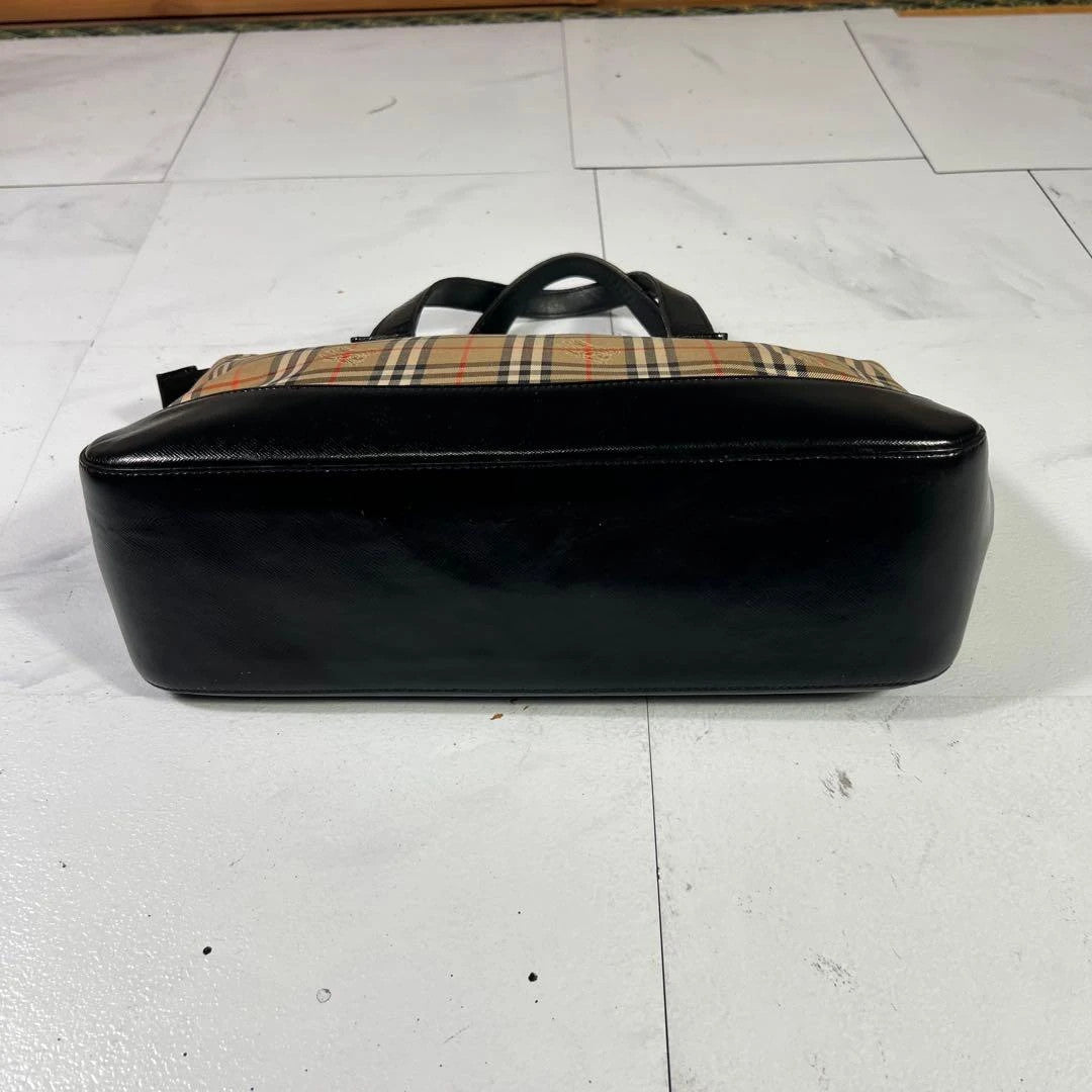 Burberry beige Nova Check tote bag with black leather base and shoulder straps.