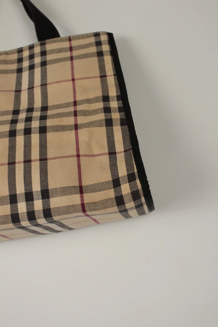 Burberry beige Nova Check tote bag with black trim and gold embossed logo plate.