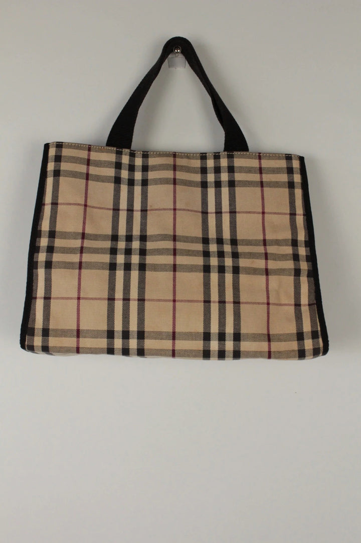 Burberry beige Nova Check tote bag with black trim and gold embossed logo plate.
