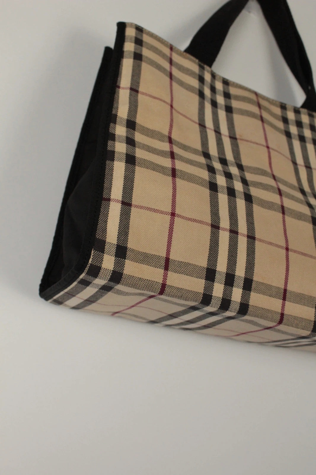 Burberry beige Nova Check tote bag with black trim and gold embossed logo plate.