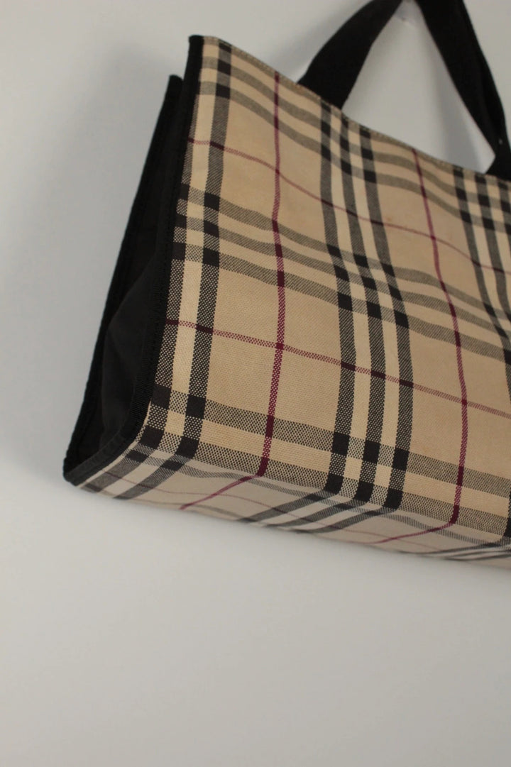 Burberry beige Nova Check tote bag with black trim and gold embossed logo plate.