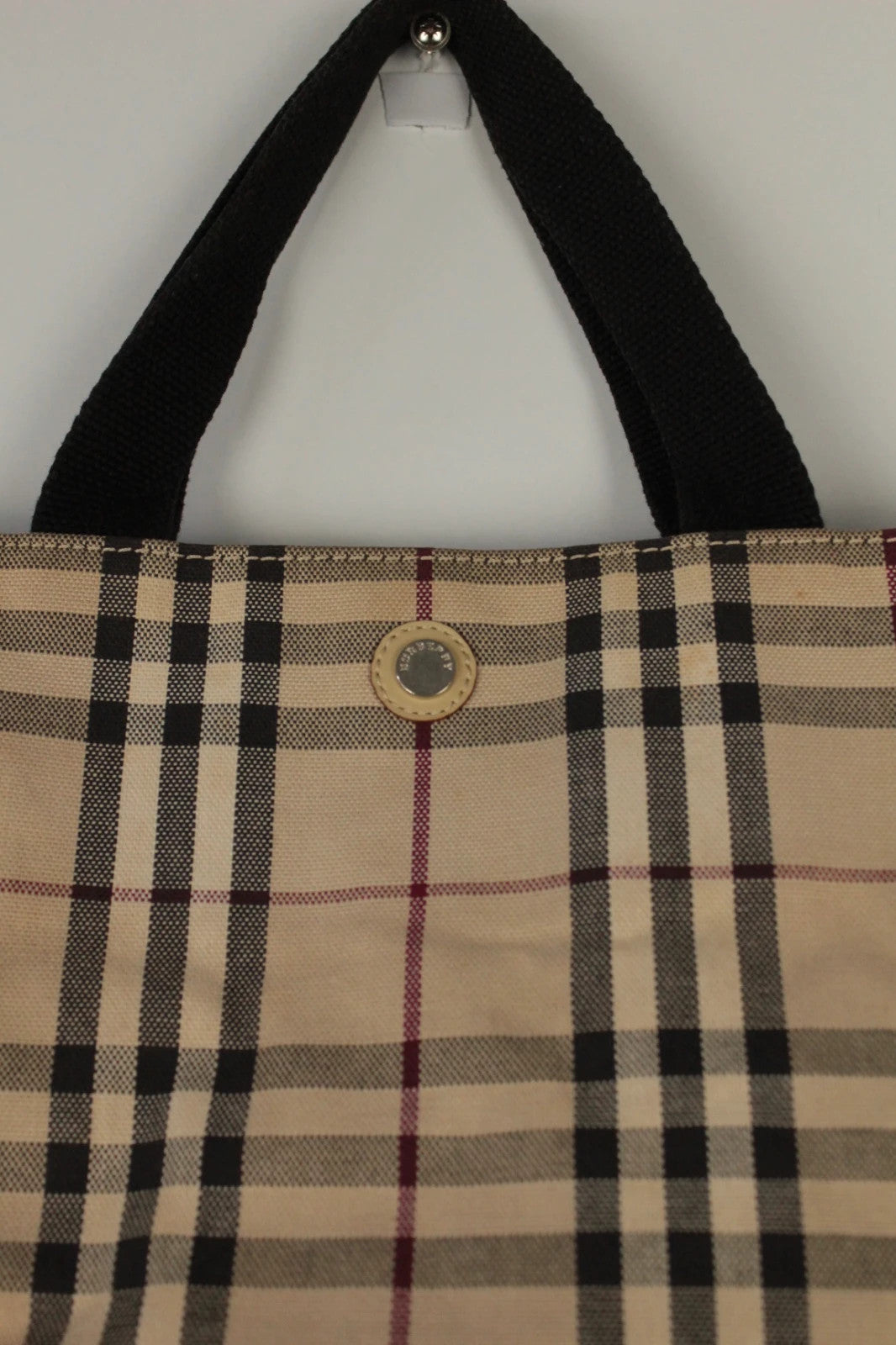 Burberry beige Nova Check tote bag with black trim and gold embossed logo plate.