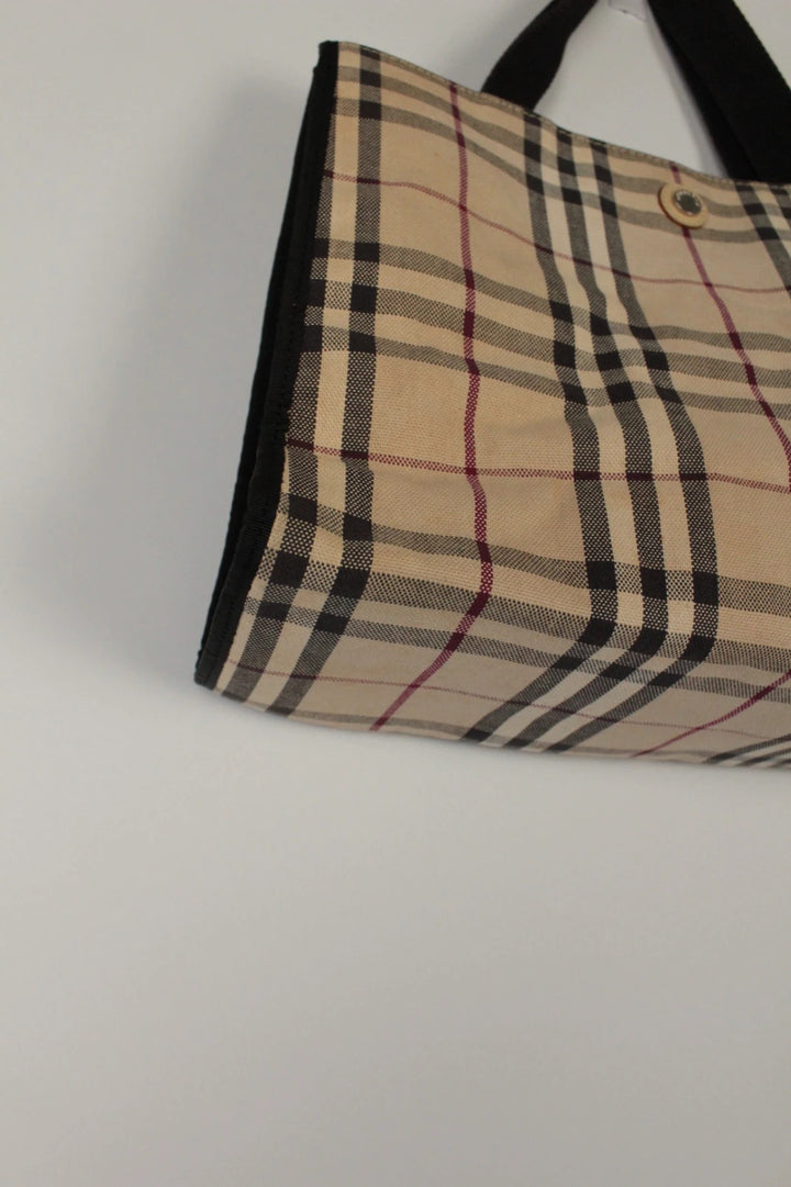 Burberry beige Nova Check tote bag with black trim and gold embossed logo plate.
