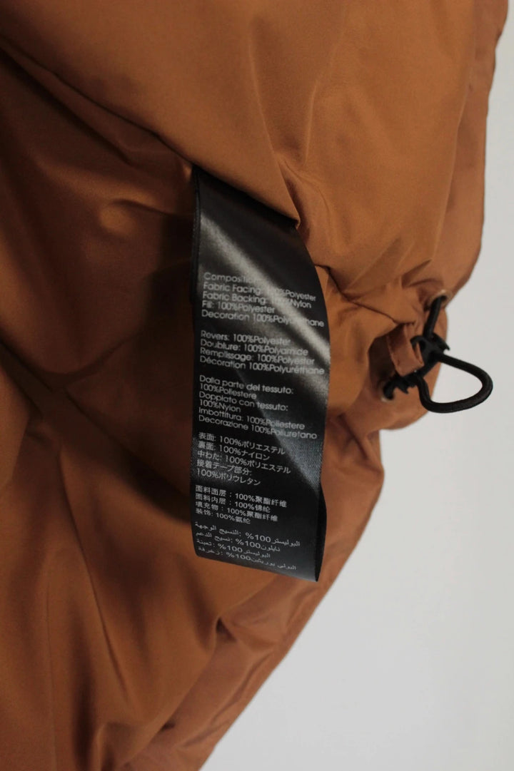 3.1 Phillip Lim brown puffer gilet vest with high-neck toggles and waterproof side-zip pockets.