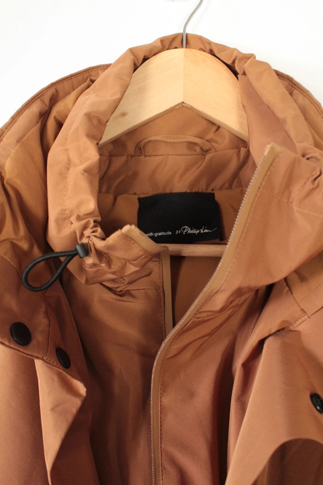 3.1 Phillip Lim brown puffer gilet vest with high-neck toggles and waterproof side-zip pockets.
