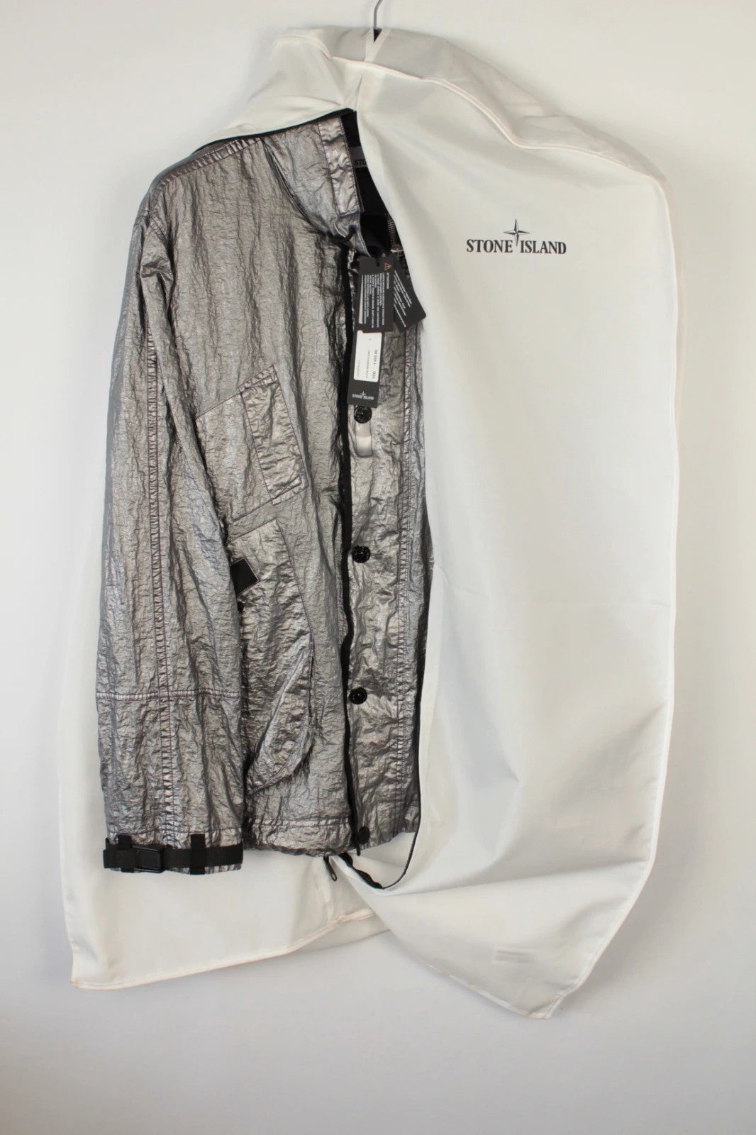 Stone Island purple and silver jacket with iridescent crinkle metal shell and logo.