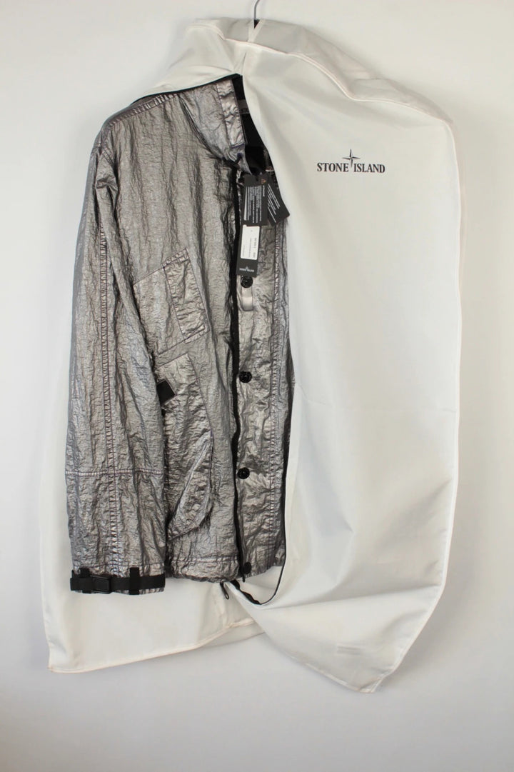 Stone Island purple and silver jacket with iridescent crinkle metal shell and logo.