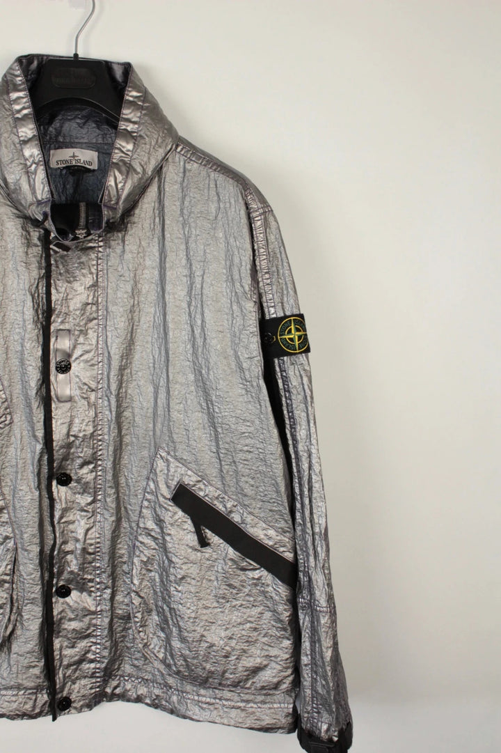 Stone Island purple and silver jacket with iridescent crinkle metal shell and logo.