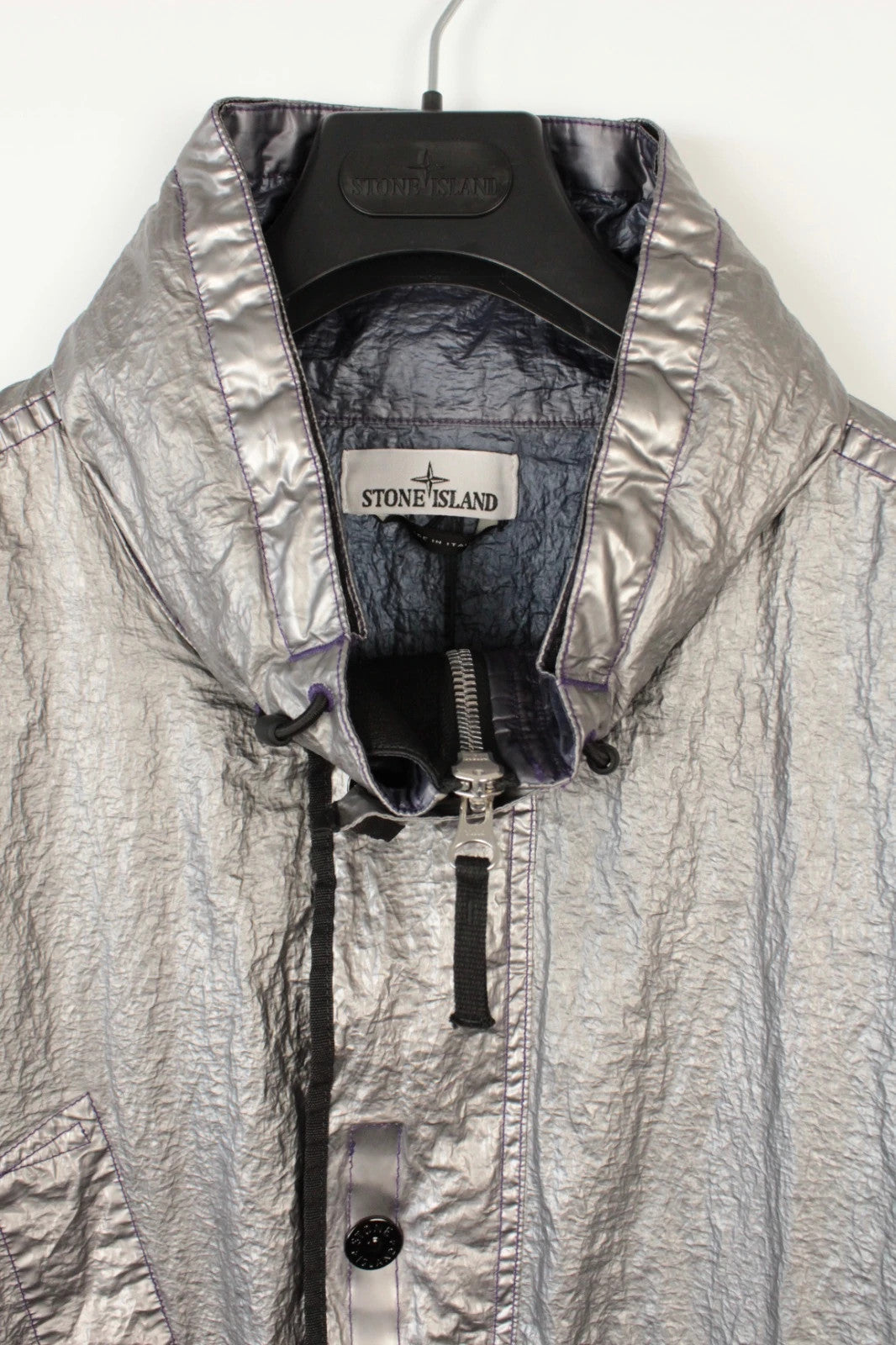 Stone Island purple and silver jacket with iridescent crinkle metal shell and logo.