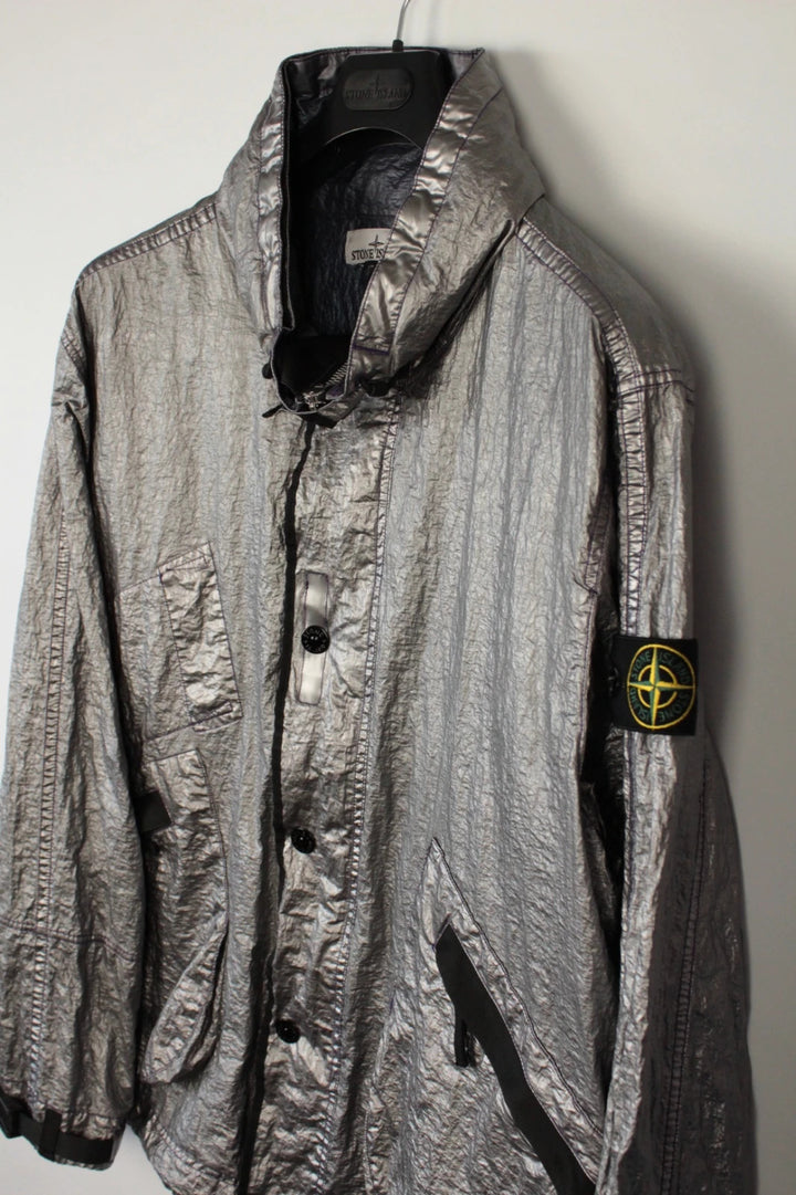 Stone Island purple and silver jacket with iridescent crinkle metal shell and logo.