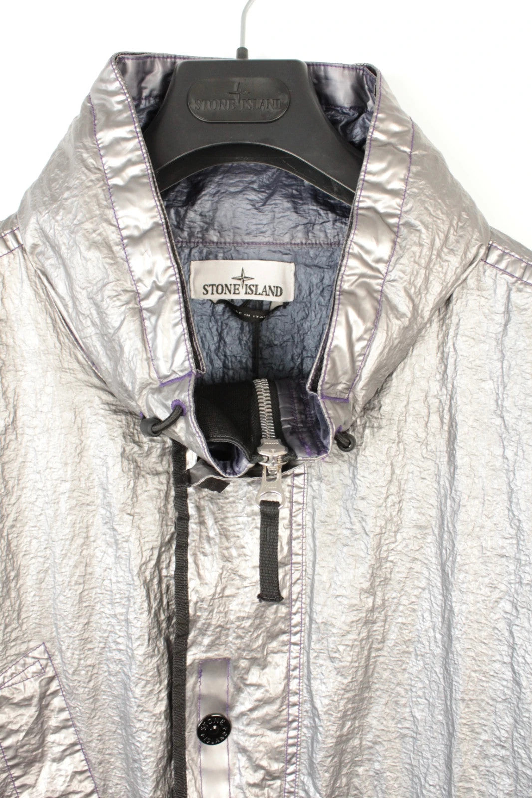 Stone Island purple and silver jacket with iridescent crinkle metal shell and logo.