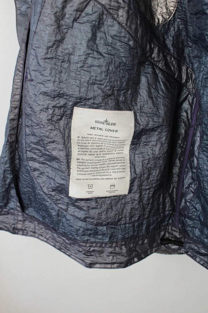 Stone Island purple and silver jacket with iridescent crinkle metal shell and logo.