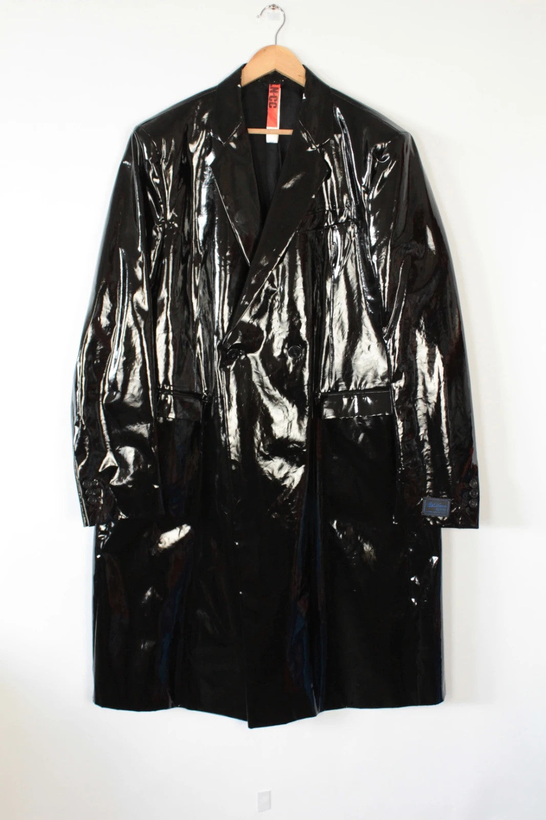Raf Simons black double-breasted trench coat glossy PVC finish with notched lapels.