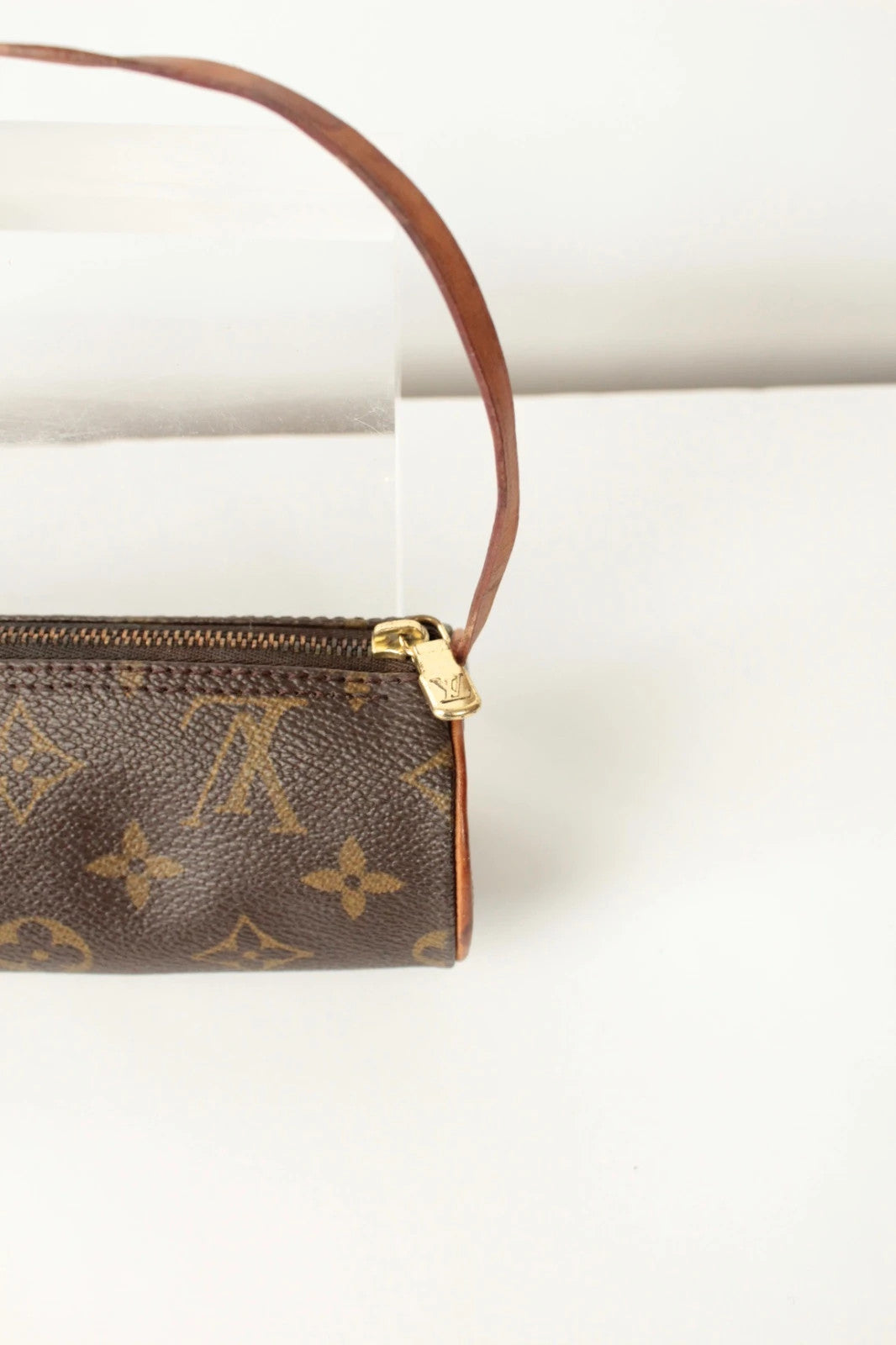 Louis Vuitton black and brown monogram micro mini pouch bag with vachetta leather trim.