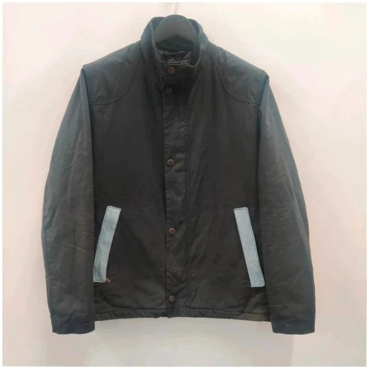 Barbour navy blouson wax jacket with quilted lining and Levi's denim pocket details.