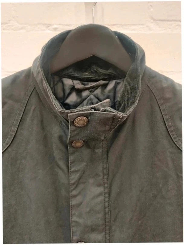Barbour navy blouson wax jacket with quilted lining and Levi's denim pocket details.