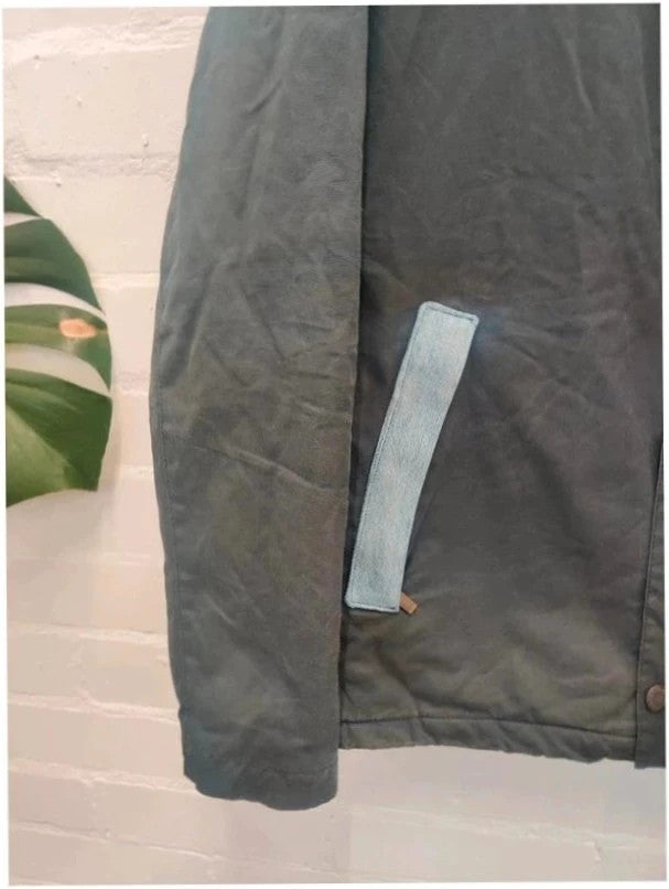 Barbour navy blouson wax jacket with quilted lining and Levi's denim pocket details.