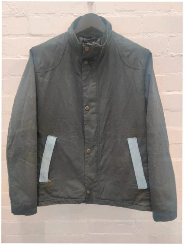 Barbour navy blouson wax jacket with quilted lining and Levi's denim pocket details.