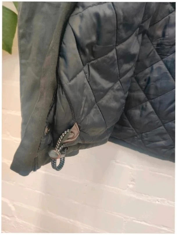 Barbour navy blouson wax jacket with quilted lining and Levi's denim pocket details.