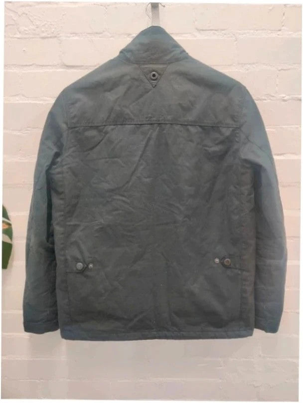 Barbour navy blouson wax jacket with quilted lining and Levi's denim pocket details.
