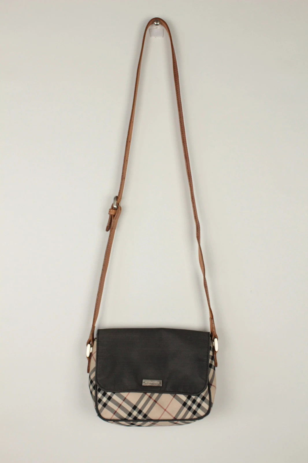 Burberry beige Nova Check crossbody handbag with black nylon flap and leather strap.