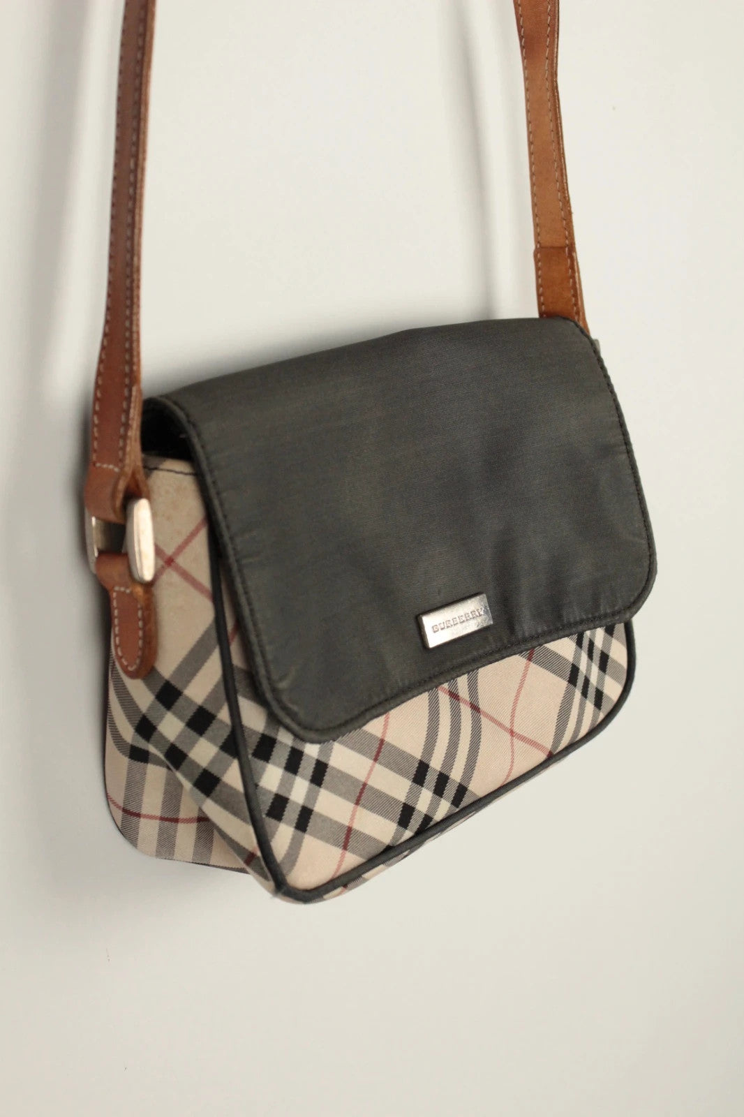 Burberry beige Nova Check crossbody handbag with black nylon flap and leather strap.
