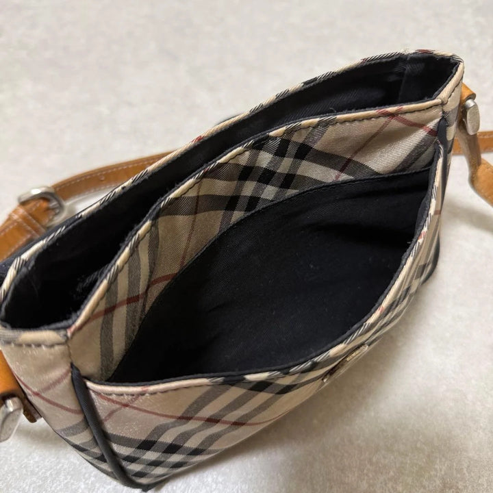 Burberry beige Nova Check crossbody handbag with black nylon flap and leather strap.