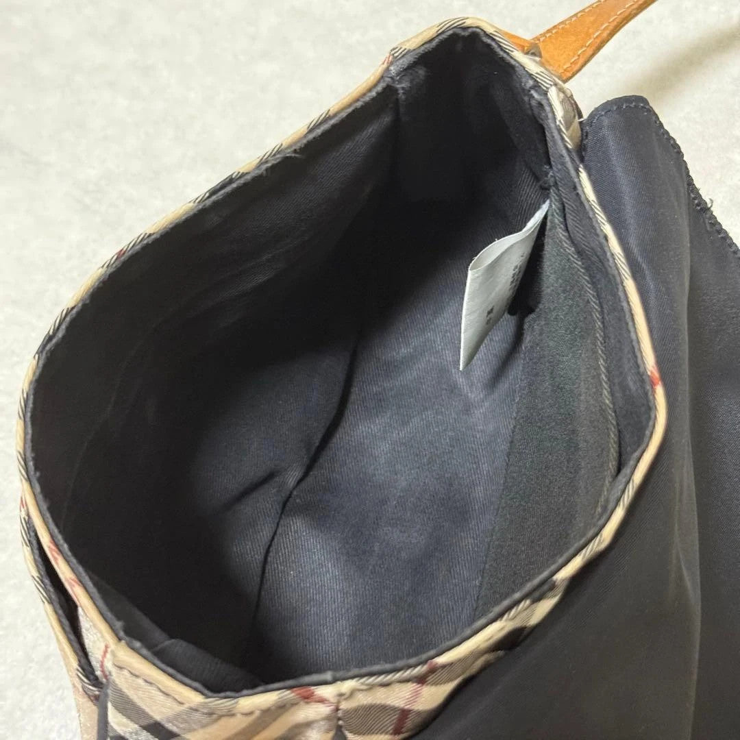 Burberry beige Nova Check crossbody handbag with black nylon flap and leather strap.